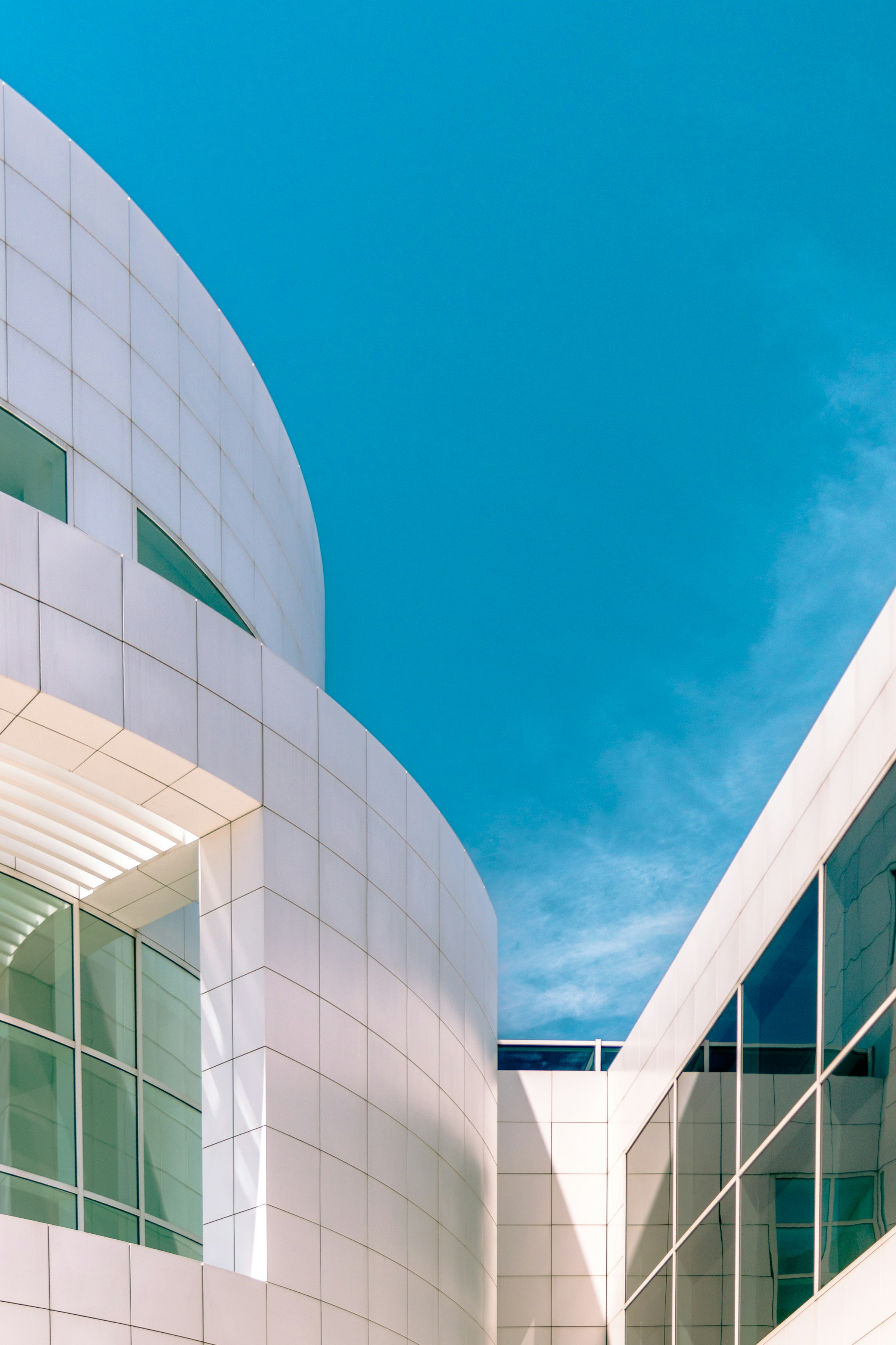 Clean white architectural lines against a bright blue sky